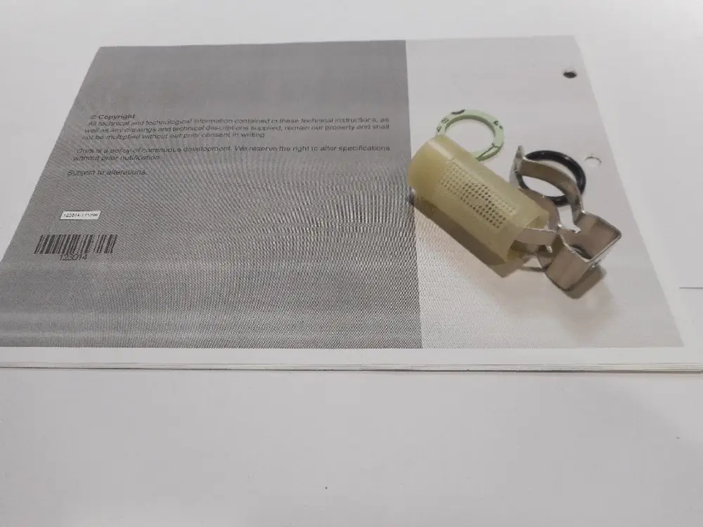 Remeha-Produkt zeigt einen Filter, der an einem grauen Hintergrund mit technischen Informationen platziert ist, daneben eine Klipsvorrichtung und ein Schlüsselring.